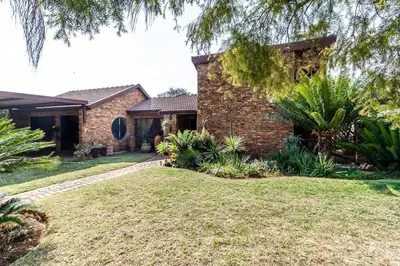 a brick house with a yard in front of it at VillaDelux in Pretoria