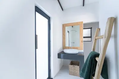 a bathroom with a sink and a mirror at Thuhlo in Marloth Park