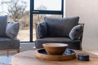 a living room with a couch and a bowl on a table at Thuhlo in Marloth Park