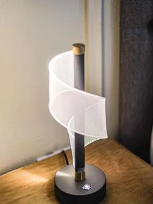 a white lamp sitting on top of a wooden table at Kamotha Guest House