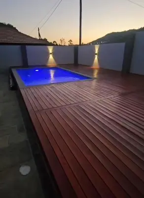 a blue pool on a deck with lights on it at Kamotha Guest House