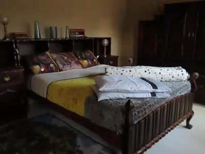 a bedroom with a bed with pillows on it at Unique Kruger Hide & Spa in Marloth Park
