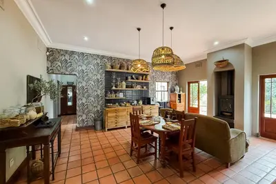 a kitchen with a table and chairs and a dining room at The Urn Guesthouse in Middelburg
