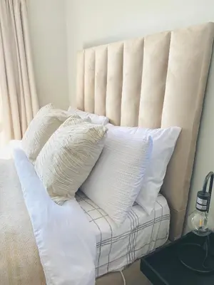 a white couch with pillows on top of it at The Minimalist Hideout in Midrand