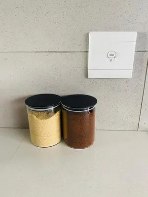 two containers of spices sitting next to a box at The Minimalist Hideout in Midrand