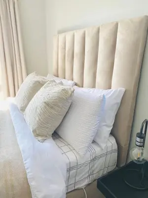 a white couch with pillows on top of it at The Minimalist Hideout in Erand