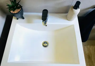 a white sink with a faucet on top of it at The Minimalist Hideout in Erand