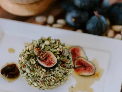 a plate of food with a fruit and nut salad at Rhino Plains in Welgevonden Game Reserve