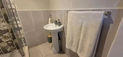 a bathroom with a sink and a shower curtain at Ekuhlaleni - A home away from home R8 in Pretoria