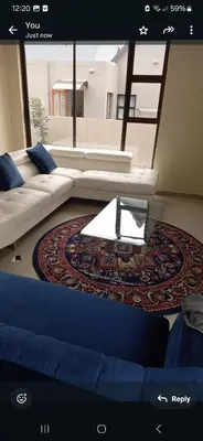 a living room with a couch and a table at Mountain view in Hartbeespoort