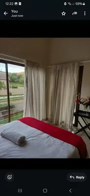 a bedroom with a large bed with a window at Mountain view in Hartbeespoort