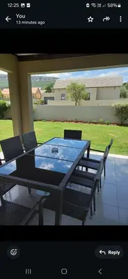 a picture of a table and chairs on a patio at Mountain view in Hartbeespoort