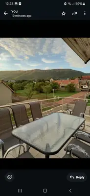 a view of a table and chairs on a balcony at Mountain view in Hartbeespoort