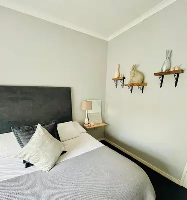 a bedroom with a bed and two birds on the wall at Follyfoot Manor in Midrand