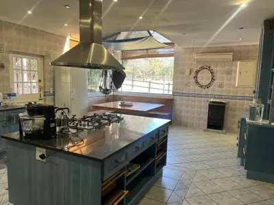 a kitchen with a stove and a counter top at Follyfoot Manor in Midrand