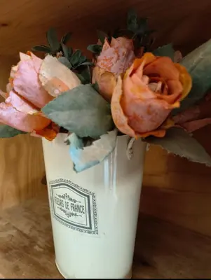 a white vase filled with flowers sitting on a table at Wag-n-Bietjie in Centurion