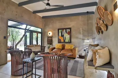 a living room with chairs and a couch at Maroela Skadu in Marloth Park in Marloth Park