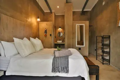 a bedroom with a large white bed in a room at Maroela Skadu in Marloth Park in Marloth Park