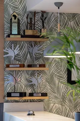 a wall with a wallpaper with birds on it at The Cycad Lodge & Chalets in Nelspruit