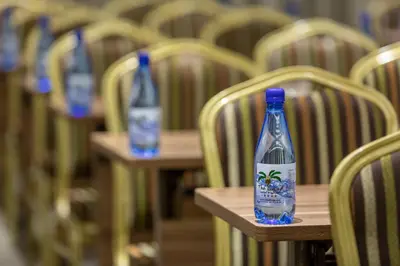 a bottle of water sitting on top of chairs at The Cycad Lodge & Chalets in Nelspruit