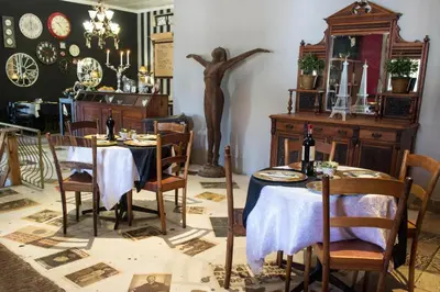 a dining room with a statue of a man on the wall at Premier Hotel and Spa Cullinan in Cullinan