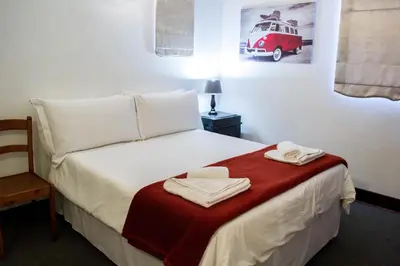 a bedroom with a bed with two towels on it at Premier Hotel and Spa Cullinan in Cullinan