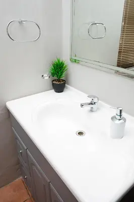a bathroom with a white sink and a mirror at 85 Ehmke Guesthouse in Nelspruit