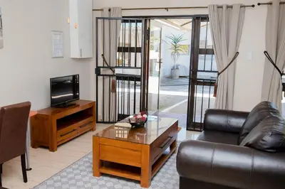 a living room with a couch and a coffee table at 85 Ehmke Guesthouse in Nelspruit