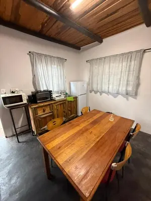 a wooden table in a room with a kitchen at Kanaan Guest Farm in Hazyview