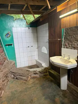a bathroom with a sink and a bath room at Kanaan Guest Farm in Hazyview