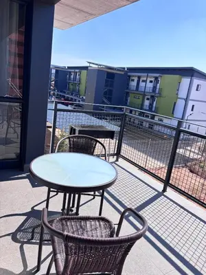 a table and chairs on the balcony of a building at Grey Heaven Retreat in Boschrand