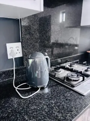 a toaster sitting on a kitchen counter next to a stove at Grey Heaven Retreat in Boschrand