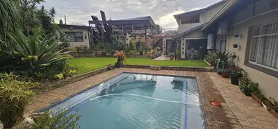 a swimming pool in the backyard of a house at Upstairs R-3 Self Catering Unit in White River