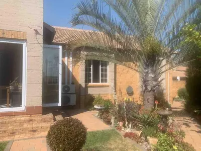a palm tree in front of a house at Imani's Retreat in Midrand
