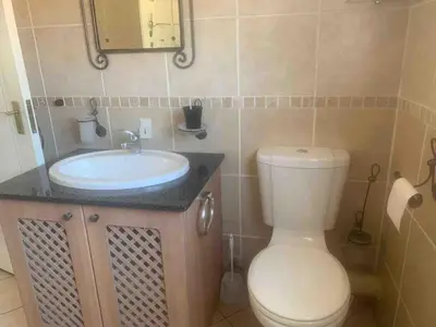 a bathroom with a toilet and a sink at Imani's Retreat in Midrand