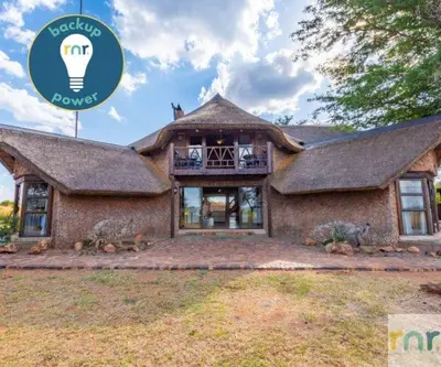 a house with a light bulb on top of it at Zebula 4-bedroom, 12 sleeper - 63 in Warmbaths
