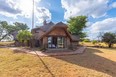 an old house with a roof in a field at Zebula 4-bedroom, 12 sleeper - 63 in Warmbaths