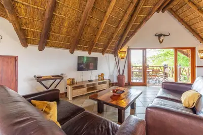 a living room with a couch and a table at Zebula 4-bedroom, 12 sleeper - 63 in Warmbaths