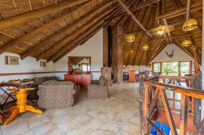 a living room with a couch and a table at Zebula 4-bedroom, 12 sleeper - 63 in Warmbaths