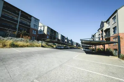 an empty parking lot in front of some buildings at Waterfall luxe apartment in Kyalami