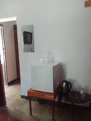 a bathroom with a white sink and a table at Mountain Guesthouse in Pretoria