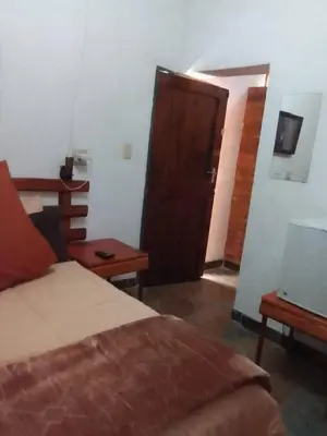 a bedroom with a bed and a wooden door at Mountain Guesthouse in Pretoria
