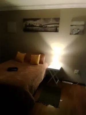 a bedroom with a bed with a light on it at New Beautiful Apartment in Middelburg