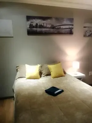 a bedroom with a large bed with yellow pillows at New Beautiful Apartment in Middelburg