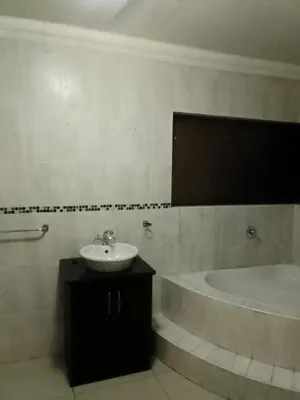 a bathroom with a sink and a bath tub at New Beautiful Apartment in Middelburg