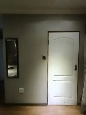 a white door in a room with a mirror at New Beautiful Apartment in Middelburg
