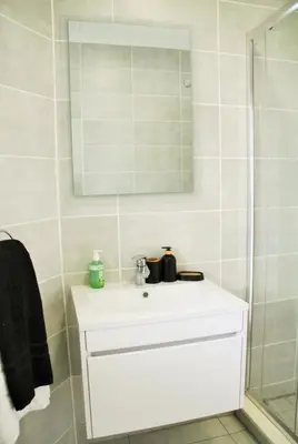 a bathroom with a white sink and a shower at Modern 2BR Retreat at The Blyde in Pretoria