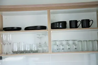 a cabinet filled with glasses and other glass items at Modern 2BR Retreat at The Blyde in Pretoria