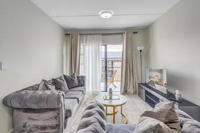 a living room with a couch and a table at 225 The Woods, Kyalami in Midrand