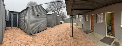 a brick walkway with a row of buildings on it at Private 4 Double Room Guest Wing, Comfortable, Secure Parking, Wi-Fi, Ensuite Bath in Ermelo